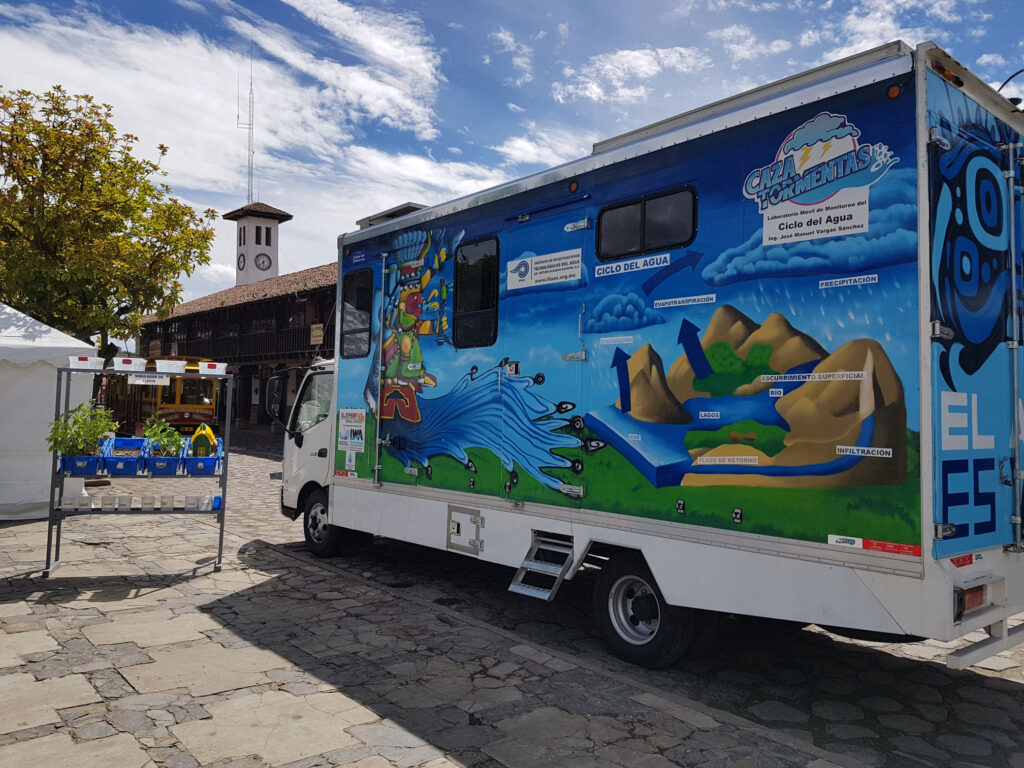 Camion decorado con imagenes de Tlaloc y el ciclo del agua estacionado en la plaza de Tapalpa, Jalisco